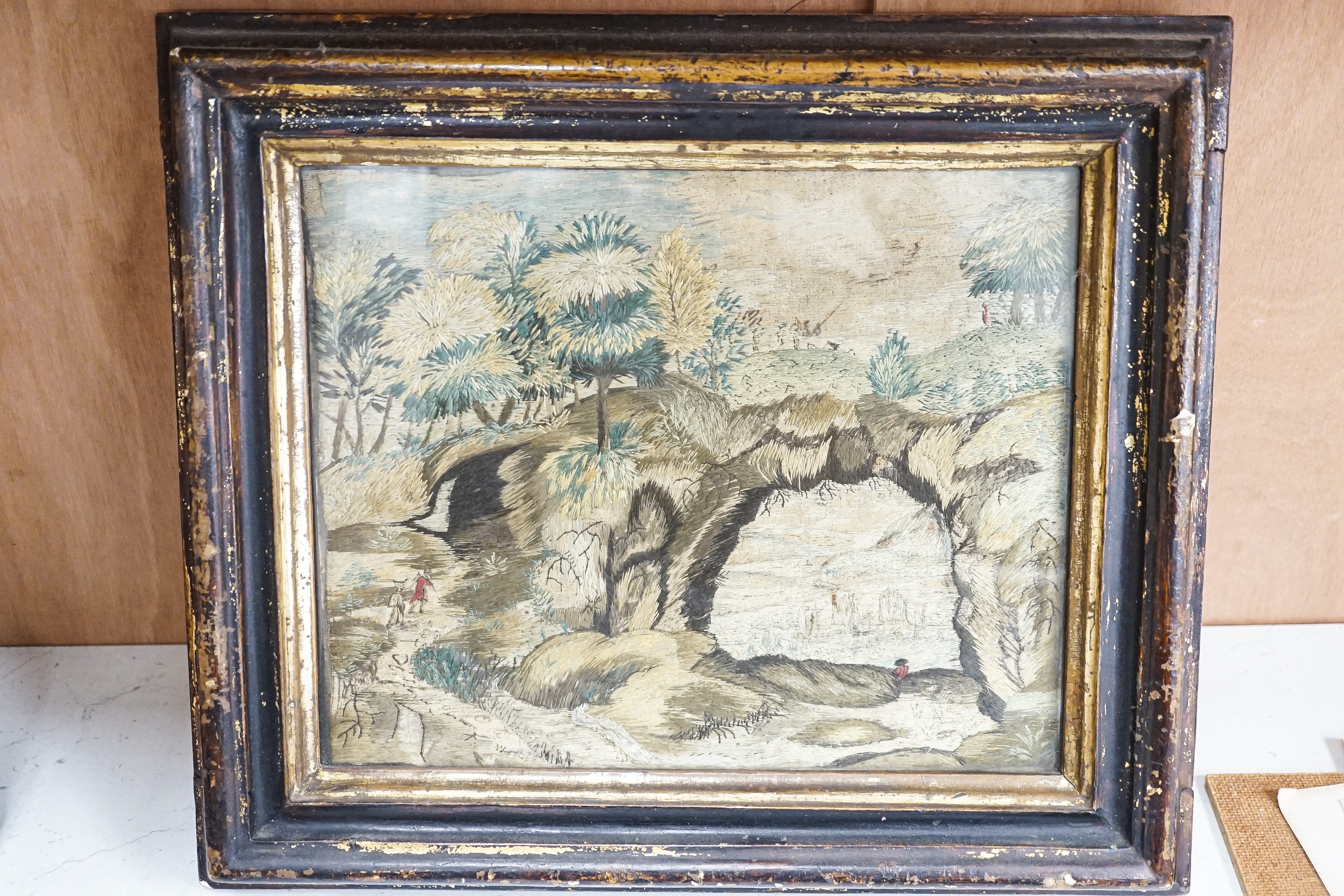 A pair of 18th century wool and silkwork pictures in ebonised frames, 26 cms high x 22 cms wide.